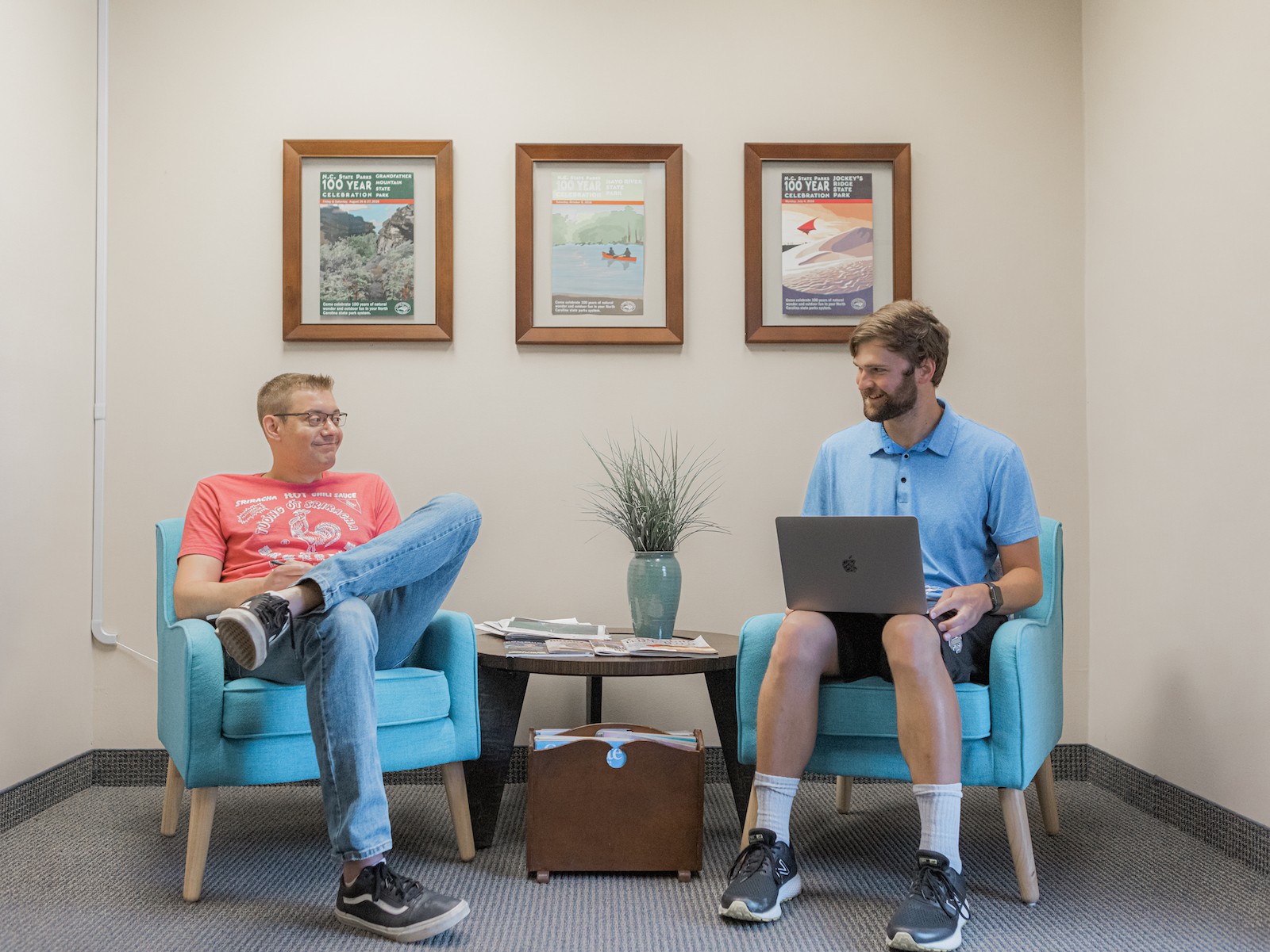 Two office workers sitting in a lobby